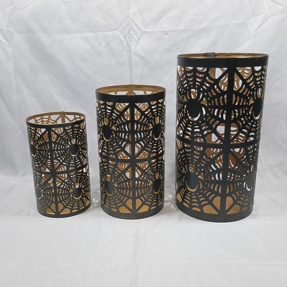 Black & gold Halloween spiderweb candle holders with intricate cut-out designs